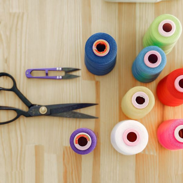 Sewing supplies - scissors, thread in different colors